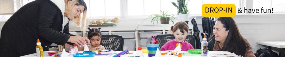 Two moms and their daughters enjoying craft activities during Open Art Studio